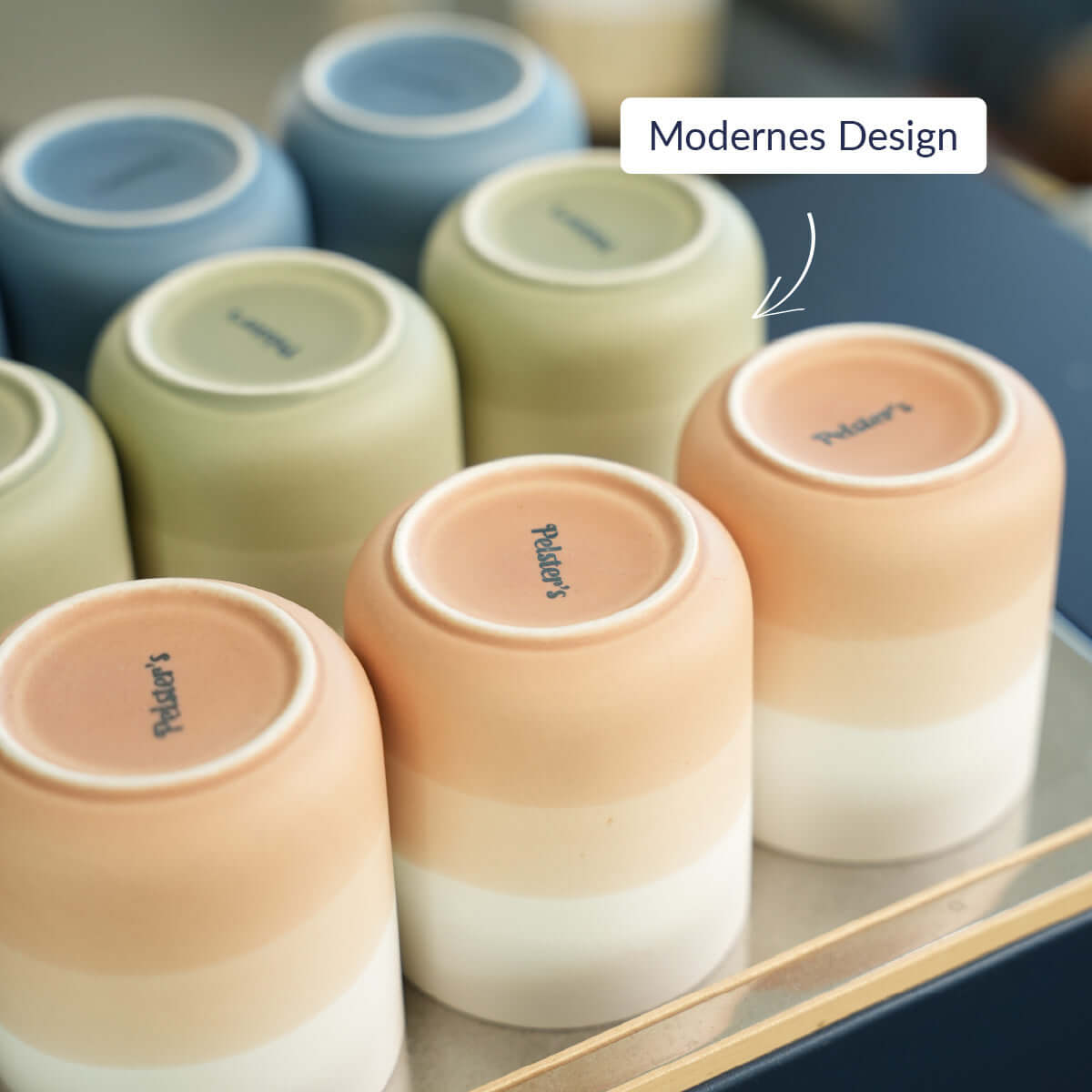 Ombré Frühstücksset aus Porzellan mit modernen Design in fünf Farben auf einem Tisch angeordnet.